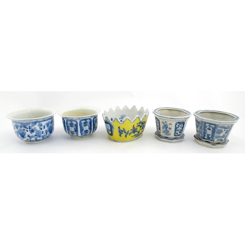 205 - A Chinese yellow ground planter with floral detail. Character marks under. Together with four blue a... 