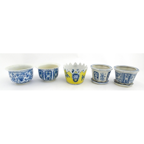 205 - A Chinese yellow ground planter with floral detail. Character marks under. Together with four blue a... 