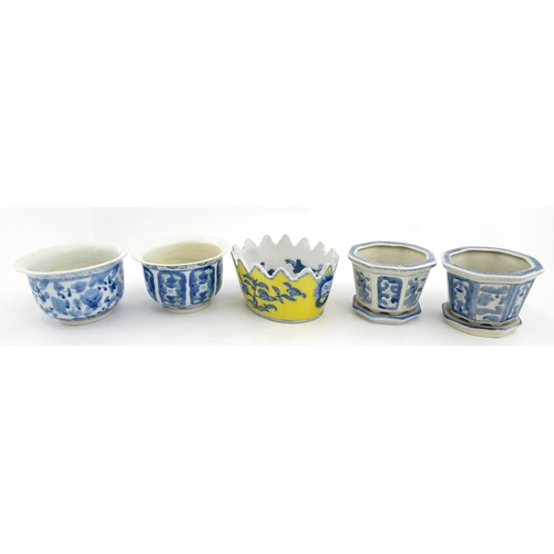 205 - A Chinese yellow ground planter with floral detail. Character marks under. Together with four blue a... 