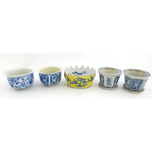 205 - A Chinese yellow ground planter with floral detail. Character marks under. Together with four blue a... 