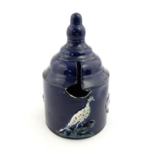 214 - A Victorian blue Measham bargeware money box decorated with birds and flowers. Approx. 7