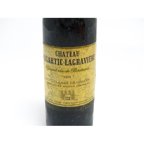 1158 - Six assorted wines and spirits, comprising a 73cl bottle of Château Malartic-Lagravière cru classe d... 