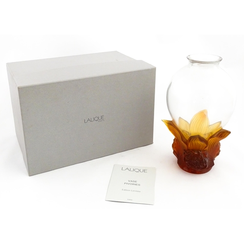 257 - A boxed limited edition Lalique Pivoines glass vase with high relief amber floral base. Limited edit... 