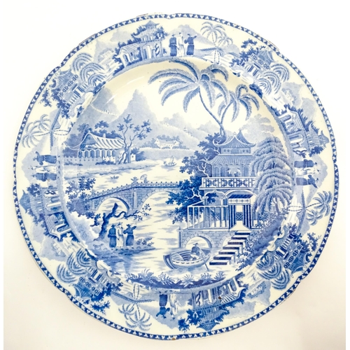 65 - A blue and white plate decorated in the Bridge and Pagoda pattern. Possibly by Thomas and John Carey... 