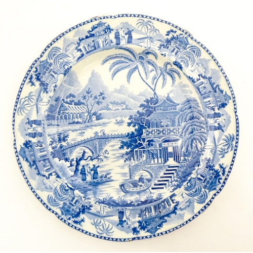 65 - A blue and white plate decorated in the Bridge and Pagoda pattern. Possibly by Thomas and John Carey... 