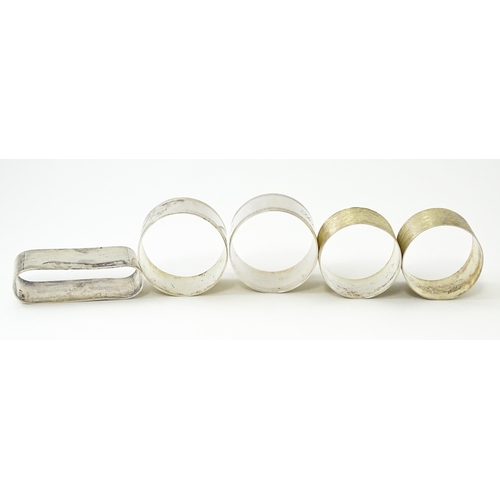 399 - Five assorted silver napkin rings to include a pair hallmarked Birmingham 1973, maker W I Broadway &... 