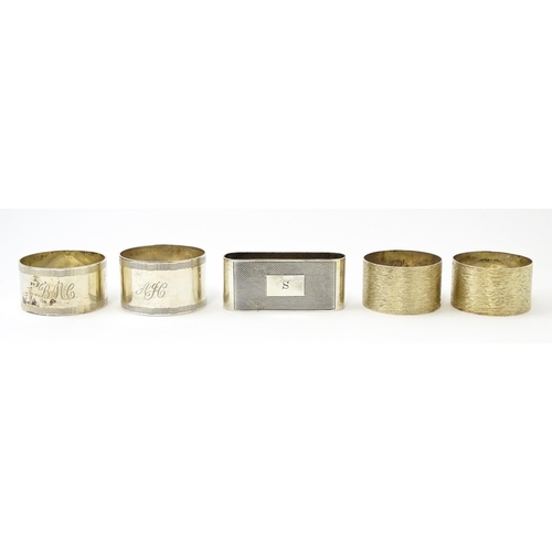 399 - Five assorted silver napkin rings to include a pair hallmarked Birmingham 1973, maker W I Broadway &... 