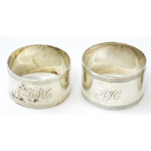 399 - Five assorted silver napkin rings to include a pair hallmarked Birmingham 1973, maker W I Broadway &... 