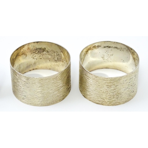 399 - Five assorted silver napkin rings to include a pair hallmarked Birmingham 1973, maker W I Broadway &... 