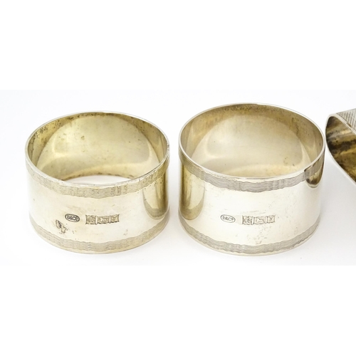 399 - Five assorted silver napkin rings to include a pair hallmarked Birmingham 1973, maker W I Broadway &... 