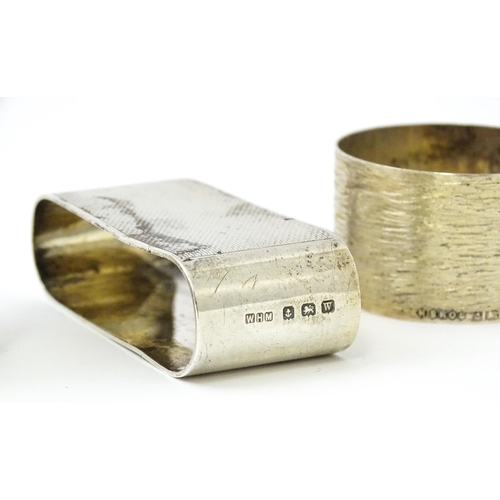 399 - Five assorted silver napkin rings to include a pair hallmarked Birmingham 1973, maker W I Broadway &... 