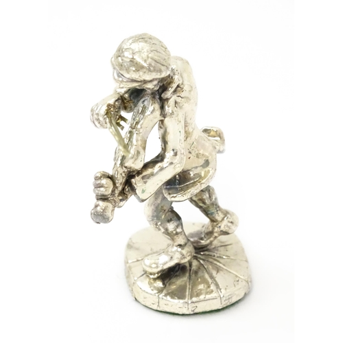 408 - A white metal model of a man playing the fiddle in the manner of Ben Zion. Approx. 2 3/4