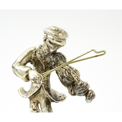 408 - A white metal model of a man playing the fiddle in the manner of Ben Zion. Approx. 2 3/4