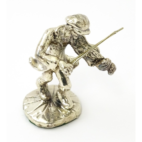 408 - A white metal model of a man playing the fiddle in the manner of Ben Zion. Approx. 2 3/4