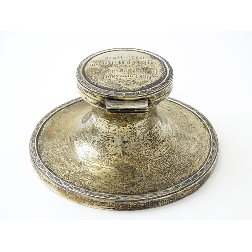 410 - A silver inkwell of capstan form with military inscription to top 'Wing Commander D. W. Edmonds D.F.... 