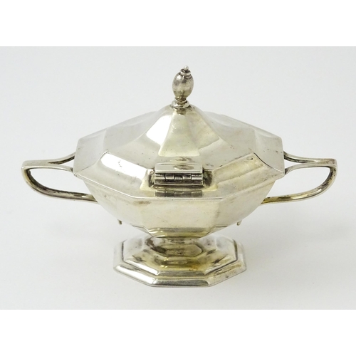 412 - A silver twin handled mustard pot hallmarked Sheffield 1909, maker Roberts & Belk. Approx. 2 1/2