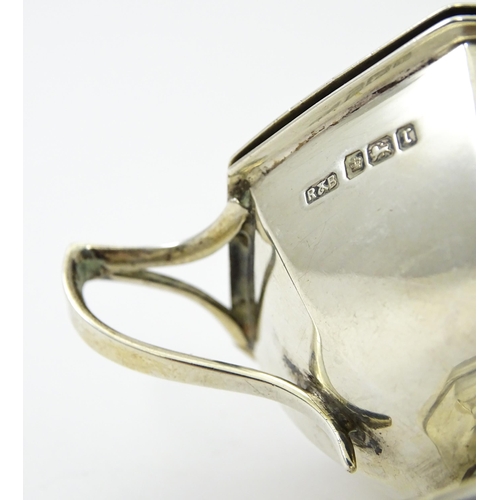 412 - A silver twin handled mustard pot hallmarked Sheffield 1909, maker Roberts & Belk. Approx. 2 1/2