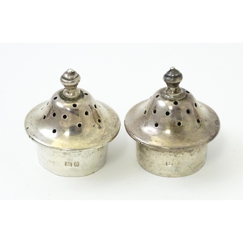 414 - A pair of silver pepperettes hallmarked Chester 1903, maker Thomas Latham & Ernest Morton. Together ... 