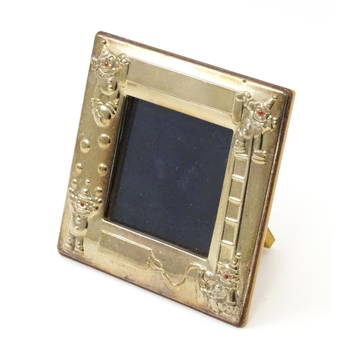 419 - An easel back photograph frame of squared form with clown detail, hallmarked Sheffield 2006, maker C... 