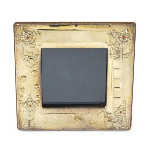 419 - An easel back photograph frame of squared form with clown detail, hallmarked Sheffield 2006, maker C... 