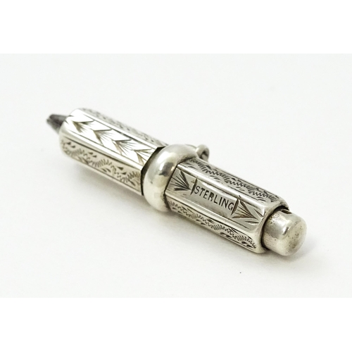 422 - A sterling silver propelling pencil with engraved decoration. Approx. 1 1/2