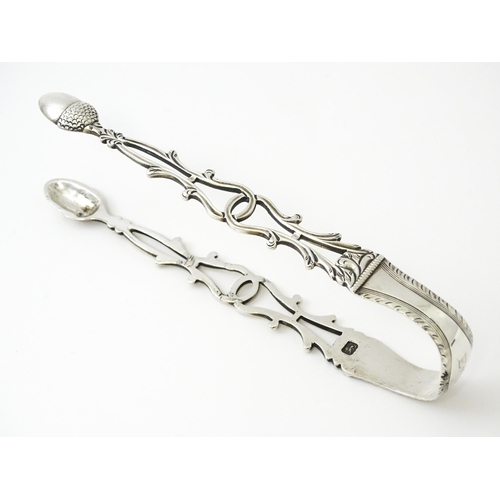 424 - 18thC silver sugar tongs with openwork decoration and acorn grips, maker W.C. Approx. 5 1/2