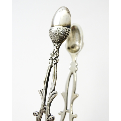 424 - 18thC silver sugar tongs with openwork decoration and acorn grips, maker W.C. Approx. 5 1/2