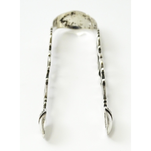 424 - 18thC silver sugar tongs with openwork decoration and acorn grips, maker W.C. Approx. 5 1/2