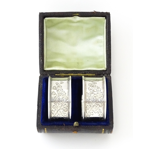 426 - A cased pair of Victorian silver napkin rings with engraved decoration hallmarked Sheffield 1885, ma... 