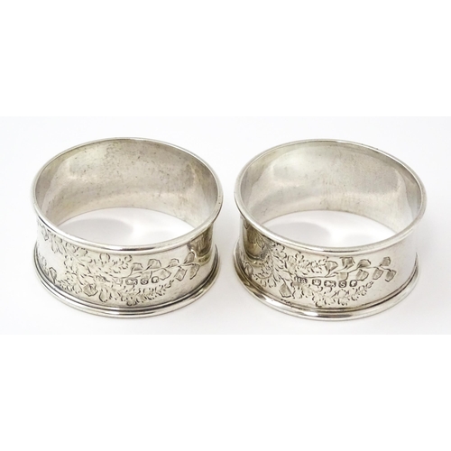 426 - A cased pair of Victorian silver napkin rings with engraved decoration hallmarked Sheffield 1885, ma... 