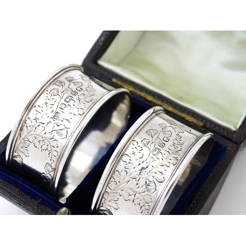 426 - A cased pair of Victorian silver napkin rings with engraved decoration hallmarked Sheffield 1885, ma... 