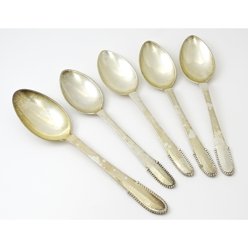 432 - Scandinavian Silver : Four Georg Jenson silver dessert spoons with beaded detail dated 1929 / 1932. ... 