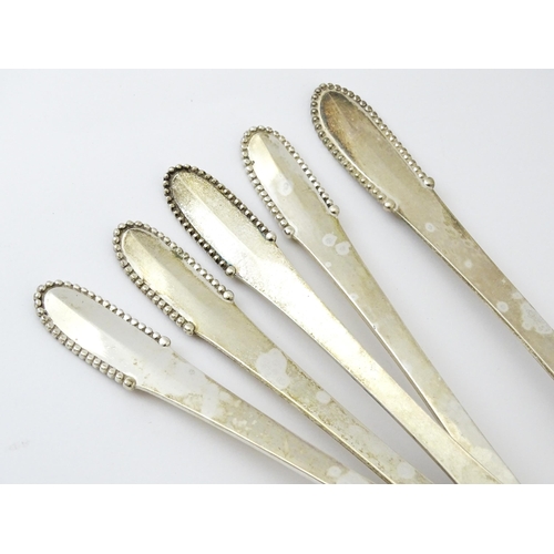 432 - Scandinavian Silver : Four Georg Jenson silver dessert spoons with beaded detail dated 1929 / 1932. ... 