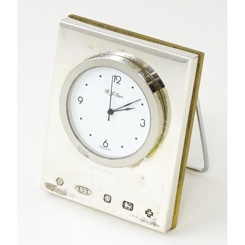 434 - An easel back desk clock with silver surround hallmarked Sheffield 2000, maker R. J. Carr. Approx. 2... 