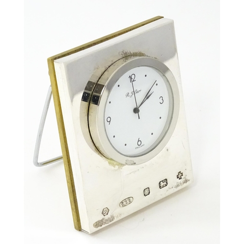 434 - An easel back desk clock with silver surround hallmarked Sheffield 2000, maker R. J. Carr. Approx. 2... 