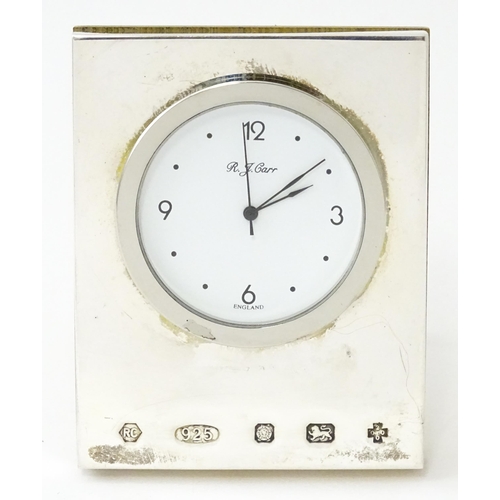 434 - An easel back desk clock with silver surround hallmarked Sheffield 2000, maker R. J. Carr. Approx. 2... 