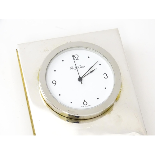 434 - An easel back desk clock with silver surround hallmarked Sheffield 2000, maker R. J. Carr. Approx. 2... 