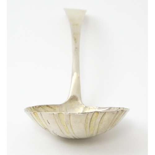 435 - An 18thC silver ladle with shell formed bowl, hallmarked London c. 1767. Approx. 6 1/2