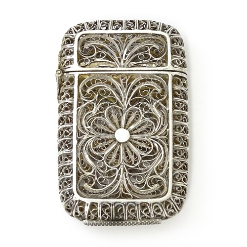 445 - A white metal vesta case with filigree decoration. Approx. 2 1/4