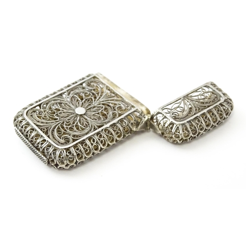 445 - A white metal vesta case with filigree decoration. Approx. 2 1/4