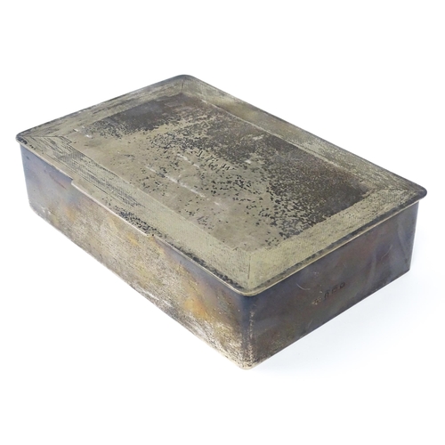 446 - An Art Deco silver cigarette box with engine turned decoration, opening to reveal a wood lined inter... 