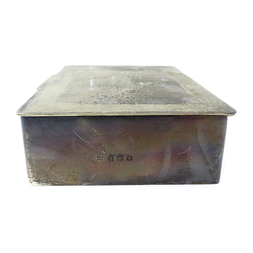 446 - An Art Deco silver cigarette box with engine turned decoration, opening to reveal a wood lined inter... 