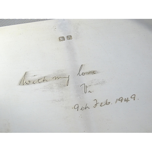 446 - An Art Deco silver cigarette box with engine turned decoration, opening to reveal a wood lined inter... 