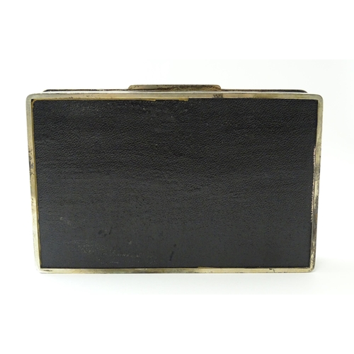 446 - An Art Deco silver cigarette box with engine turned decoration, opening to reveal a wood lined inter... 
