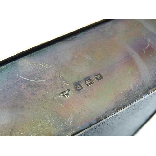 446 - An Art Deco silver cigarette box with engine turned decoration, opening to reveal a wood lined inter... 