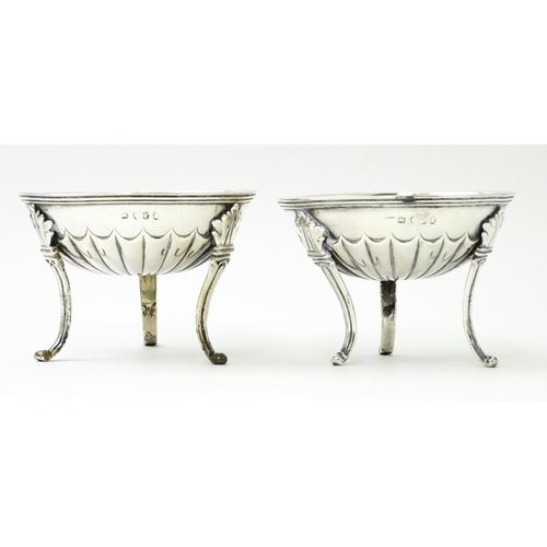 447 - A pair of unusual George III silver salts of circular form raised on three feet, hallmarked London 1... 