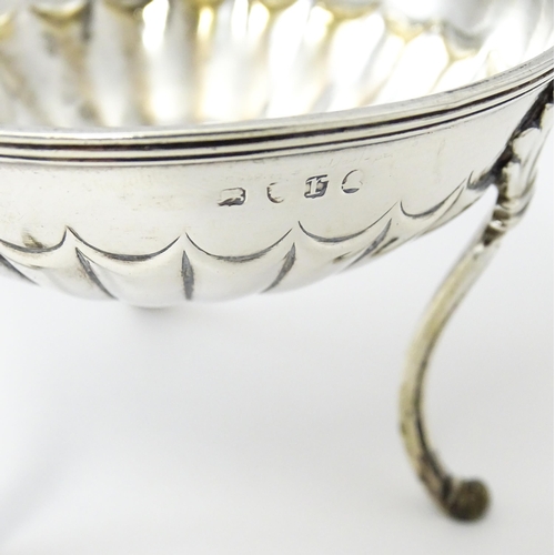 447 - A pair of unusual George III silver salts of circular form raised on three feet, hallmarked London 1... 