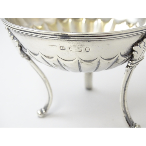 447 - A pair of unusual George III silver salts of circular form raised on three feet, hallmarked London 1... 