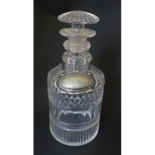 268 - A small 19thC three ring glass decanter with silver plate label. Approx. 7 1/2