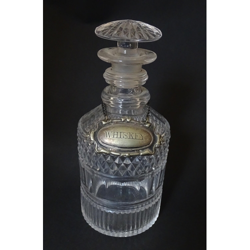 268 - A small 19thC three ring glass decanter with silver plate label. Approx. 7 1/2